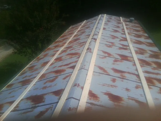 Rusted metal roof panels with new wood purlins before replacement — Storm Damage Roof Repair in Saint Catharine by Roofing Brothers